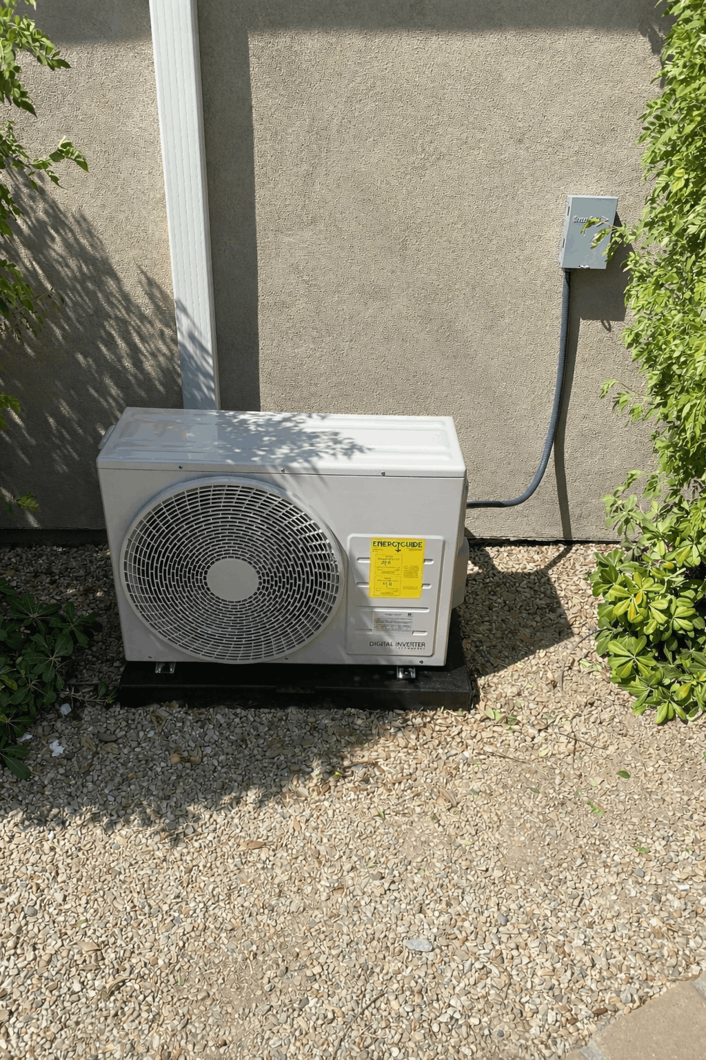 A ductless mini split outdoor unit installed beside a home