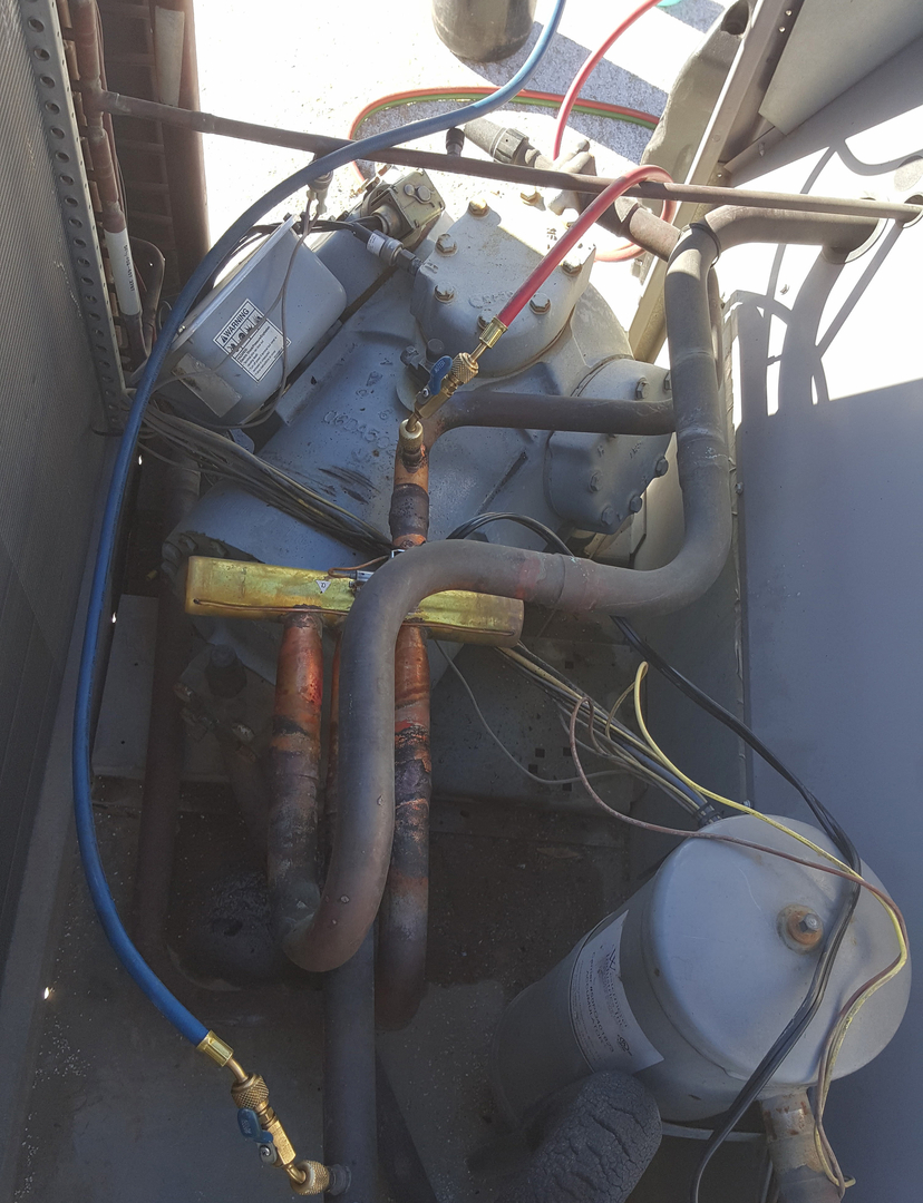 Compressor and refrigerant piping inside an HVAC unit